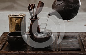 Cropped shot of woman pouring tea in traditional chinese teaware
