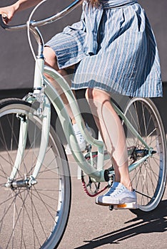 cropped shot of woman riding on bicycle