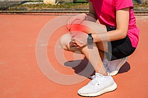 Cropped shot of woman runner suffering from Iliotibial Band Syndrome ITB.