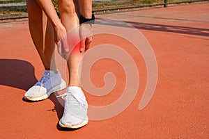 Cropped shot of woman runner suffering pain from Shin splint.