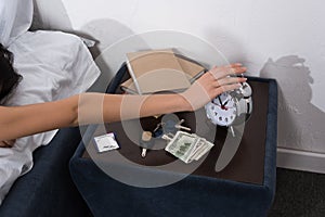 Woman setting off alarm clock