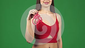 Cropped shot of a woman smiling seductively holding handcuffs