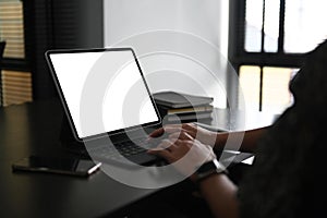 Cropped shot of yong woman hand typing on keyborad of computer tablet.