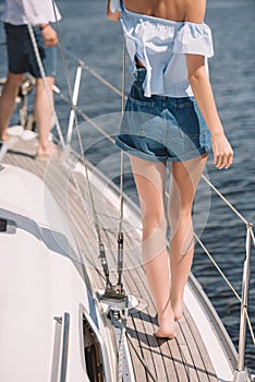 cropped shot of young barefoot couple standing