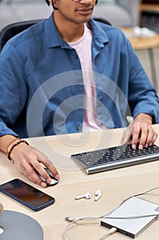 Cropped shot of young black man using computer male hand holding mouse