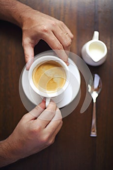 Cropped shot of young businessman with cup of coffee