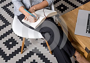 Cropped shot of young businesswoman writing notes