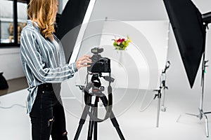 cropped shot of young female photographer shooting flowers
