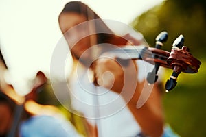 Music is life thats why our hearts have beats. Cropped shot of a young girl playing a violin outdoors.