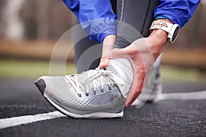 Cropped shot of a young man holding his ankle in pain sprain a f photo