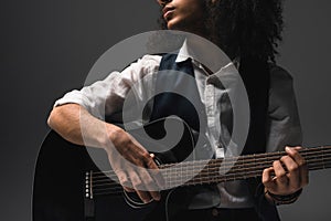 cropped shot of young musician playing acoustic guitar