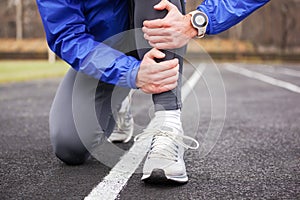 Cropped shot of a young runner holding his leg in pain.