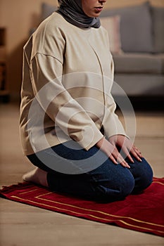 Cropped shot of young woman in beige pullover and blue jeans