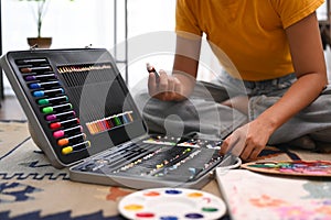 Cropped shot of young woman choosing color for creative artwork. Art, creative hobby and leisure activity concept