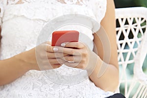 Cropped shot of young woman`s hand with her mobile phone