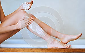 Get ready for a leggy day. Cropped shot of a young woman shaving her legs in the bathroom.