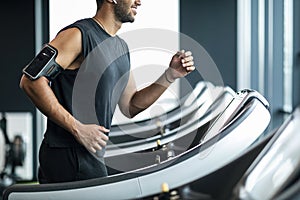 Cropped Of Smiling Black Man In Sportswear Jogging On Treadmill At Gym