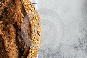 Cropped sourdough bread with oats. Gray background and copy space