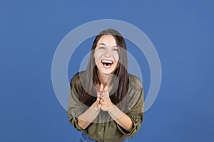 Cropped studio shot of laughing woman isolated over blue background, happiness
