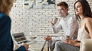 Cropped tourist agent showing clipboard to couple