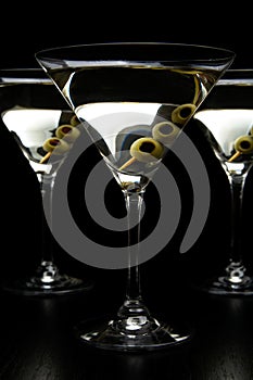 Cropped Vermouth Martini drinks with olives isolated on black