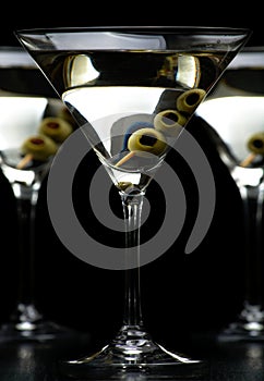 Cropped Vermouth Martini drinks with olives isolated on black