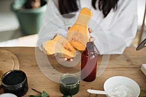 Cropped view of beautiful healthy asian woman preparing natural cosmetics