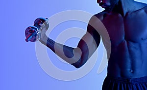 Cropped view of black bodybuilder with bare torso training with dumbbells, pumping iron in neon lighting