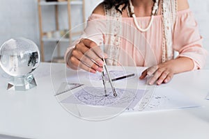cropped view of blurred astrologist drawing photo