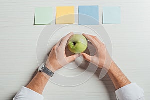 Cropped view of businessman holding apple