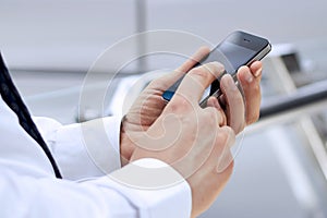 Cropped view of Businessman holding the mobile phone