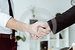 cropped view of businesspeople shaking hands