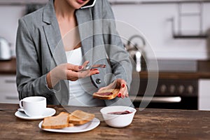 Cropped view of businesswoman holding toast