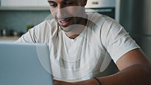 Cropped view close up male hands typing laptop. Smiling successful African man guy freelancer work online distant