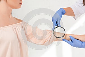 Cropped view of dermatologist examining skin