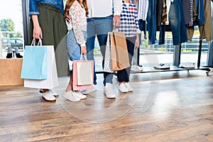 cropped view of family with shopping bags