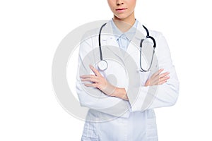 cropped view of female doctor in white coat with stethoscope and crossed arms,