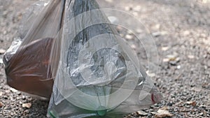 Cropped view of garbage bag in process of colecting litter