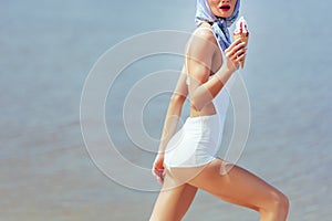 cropped view of girl in vintage white swimwear holding waffle cone