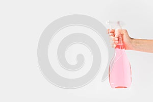 cropped view of hand holding pink spray bottle,