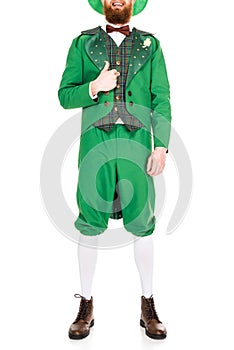 Cropped view on leprechaun in green suit and hat with thumb up