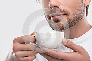 cropped view of man drinking aromatic coffee