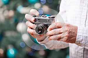 Cropped view of man holding retro camera