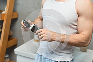 cropped view of man opening antiperspirant