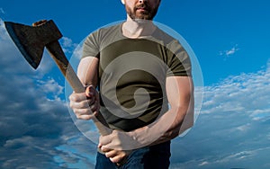 cropped view of man threaten with axe. caucasian man hold ax. brutal man on sky background