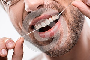 cropped view of man using dental floss