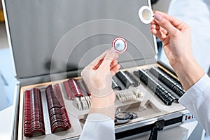 Cropped view of ophthalmologist holding lenses