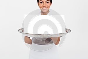 Cropped view photo of young female waiter holding metal tray wit