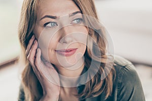 Cropped view portrait of attractive peaceful dreamy wavy-haired woman fantasizing touching face spending time staying at