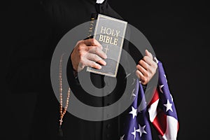 Cropped view of priest holding holy